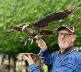 Seamus holding his Fish Eagle sculpture in the garden